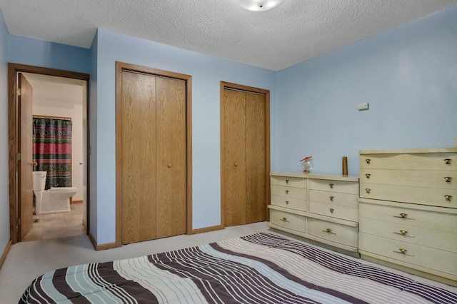 607 Wilson St, Downing, WI 54734 - carpeted bedroom with multiple closets, a textured ceiling, and baseboards