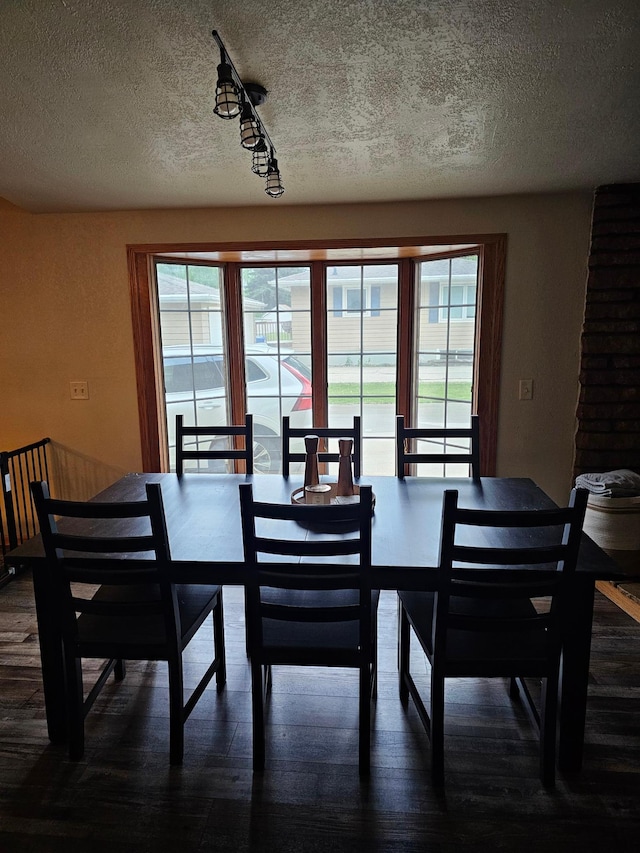 1005 8th Ave SW, Pipestone, MN 56164 - dining area with a textured ceiling, healthy amount of natural light, and dark wood-style flooring
