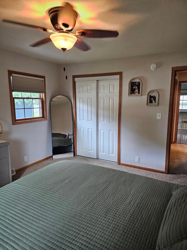 1005 8th Ave SW, Pipestone, MN 56164 - unfurnished bedroom featuring carpet, a closet, a ceiling fan, a textured ceiling, and baseboards