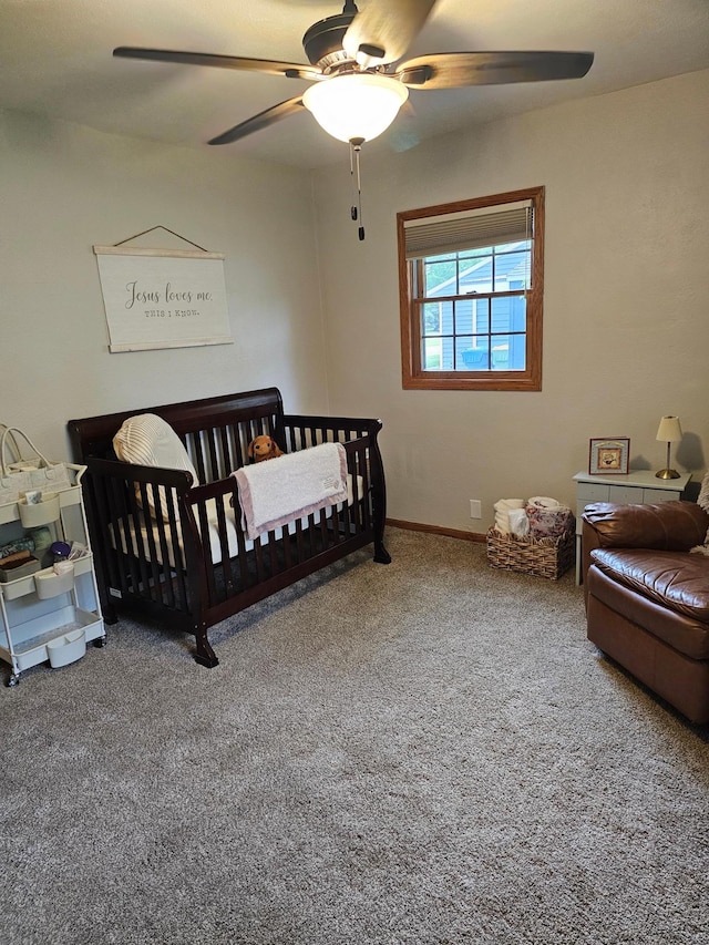 1005 8th Ave SW, Pipestone, MN 56164 - carpeted bedroom with a nursery area, ceiling fan, and baseboards