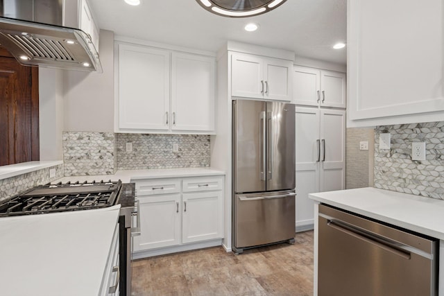 4613 34th Ave S, Minneapolis, MN 55406 - kitchen featuring appliances with stainless steel finishes, range hood, decorative backsplash, white cabinets, and recessed lighting