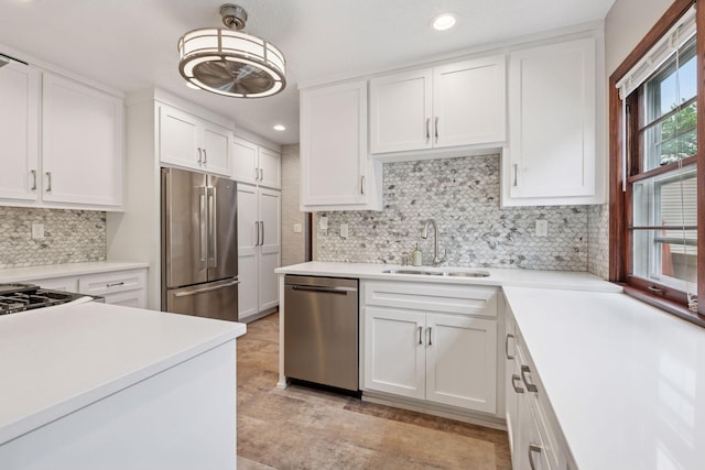 4613 34th Ave S, Minneapolis, MN 55406 - kitchen featuring appliances with stainless steel finishes, a sink, light countertops, white cabinets, and tasteful backsplash