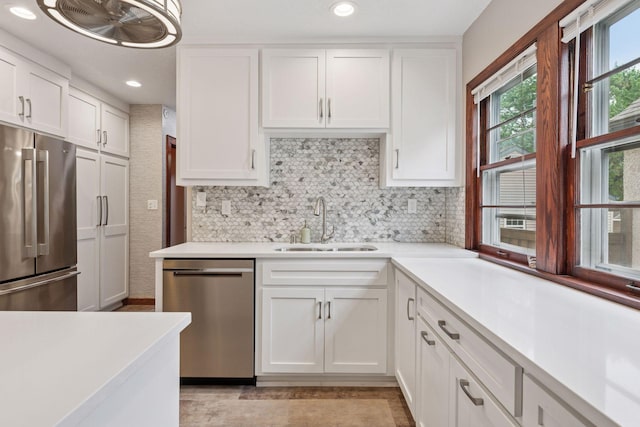 4613 34th Ave S, Minneapolis, MN 55406 - kitchen featuring appliances with stainless steel finishes, a sink, light countertops, white cabinetry, and recessed lighting