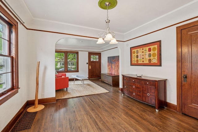 4613 34th Ave S, Minneapolis, MN 55406 - foyer featuring arched walkways, dark wood finished floors, baseboards, crown molding, and a chandelier