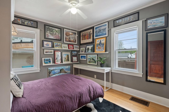 4613 34th Ave S, Minneapolis, MN 55406 - bedroom featuring wood finished floors, crown molding, baseboards, and a ceiling fan