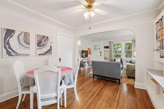 4613 34th Ave S, Minneapolis, MN 55406 - dining area with arched walkways, wood finished floors, a ceiling fan, crown molding, and baseboards