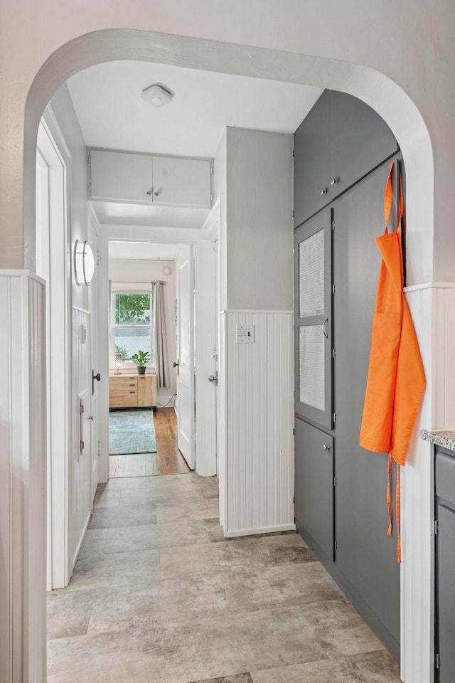4613 34th Ave S, Minneapolis, MN 55406 - corridor with light wood-style floors, arched walkways, and a wainscoted wall