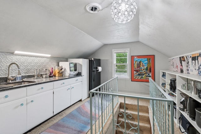 4613 34th Ave S, Minneapolis, MN 55406 - kitchen featuring a sink, white cabinets, lofted ceiling, decorative backsplash, and dark stone countertops