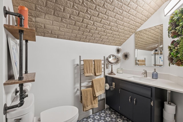4613 34th Ave S, Minneapolis, MN 55406 - bathroom with brick ceiling, toilet, and vanity