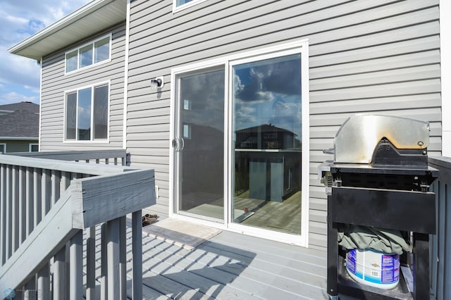 wooden terrace featuring a grill