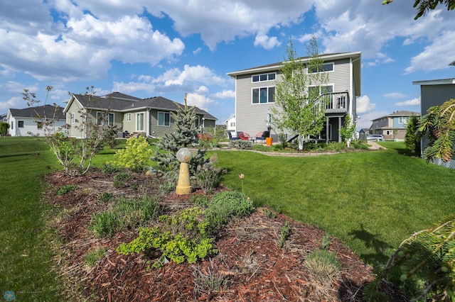 rear view of property with a lawn and a residential view