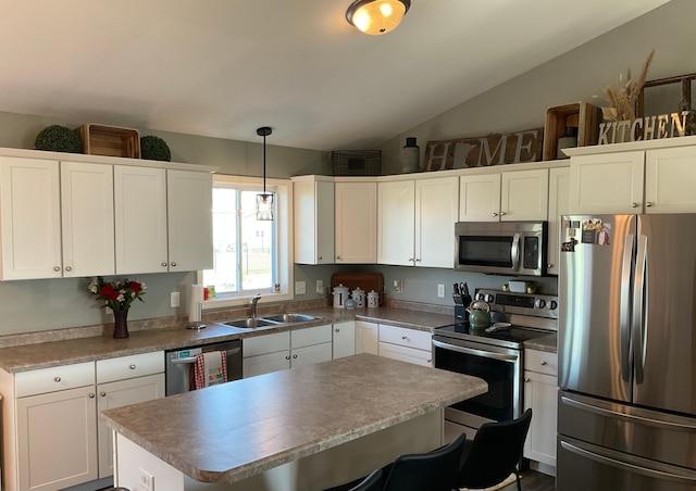 1218 8th Ave NW, Perham, MN 56573 - kitchen with stainless steel appliances, a sink, white cabinetry, a center island, and vaulted ceiling