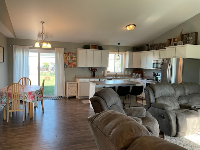 1218 8th Ave NW, Perham, MN 56573 - living area with lofted ceiling, dark wood finished floors, and a chandelier