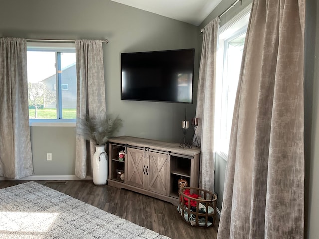 1218 8th Ave NW, Perham, MN 56573 - living room with dark wood finished floors, lofted ceiling, and baseboards
