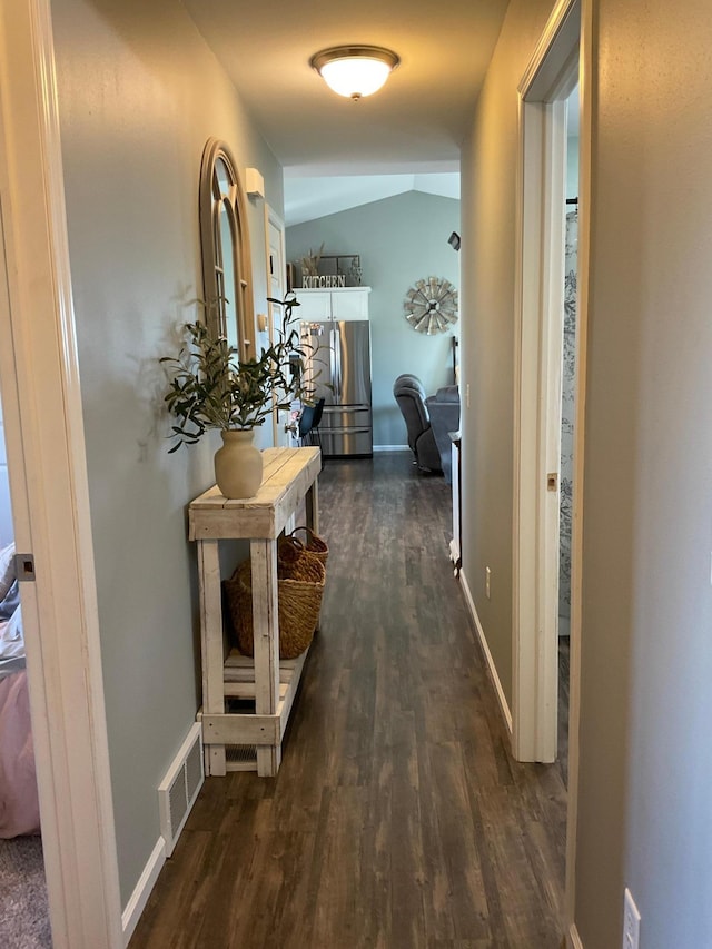 1218 8th Ave NW, Perham, MN 56573 - hall with dark wood-type flooring, baseboards, and lofted ceiling