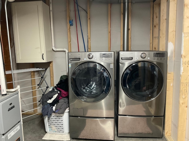 1218 8th Ave NW, Perham, MN 56573 - laundry room with washer and clothes dryer and cabinet space
