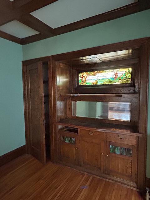 bar featuring light wood-style flooring and baseboards