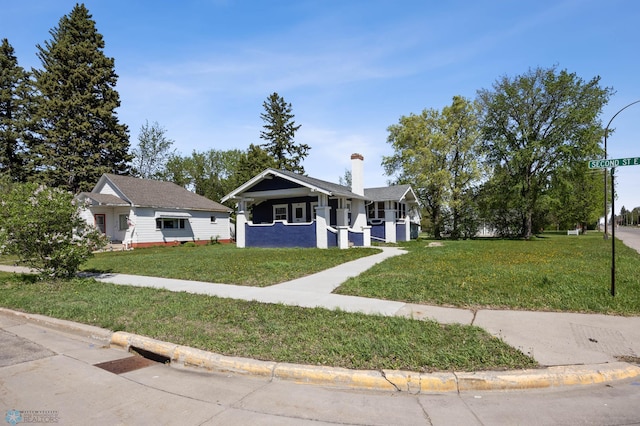 12 2nd St E, Ada, MN 56510 - bungalow-style house featuring a front lawn and a chimney