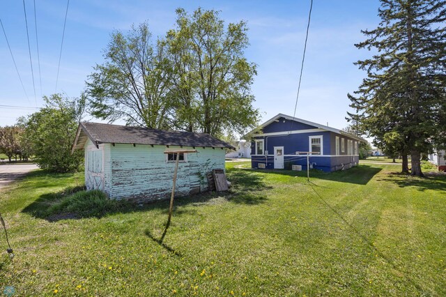 12 2nd St E, Ada, MN 56510 - view of grassy yard featuring an outbuilding