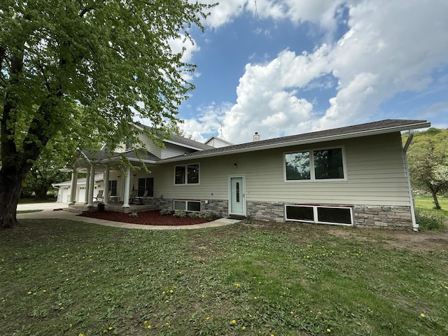 4615 County Road 5 NW, Byron, MN 55920 - back of house with an attached garage, a yard, concrete driveway, and covered porch