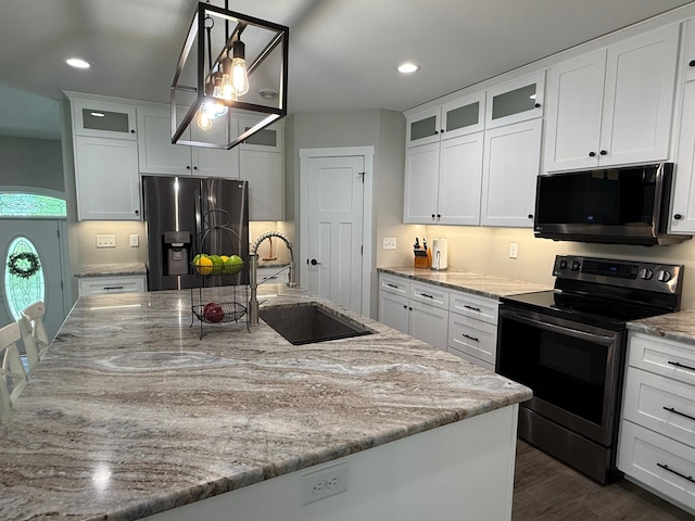 4615 County Road 5 NW, Byron, MN 55920 - kitchen with appliances with stainless steel finishes, a sink, light stone counters, a center island with sink, and white cabinetry