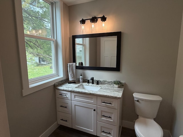 4615 County Road 5 NW, Byron, MN 55920 - bathroom with baseboards, vanity, and toilet