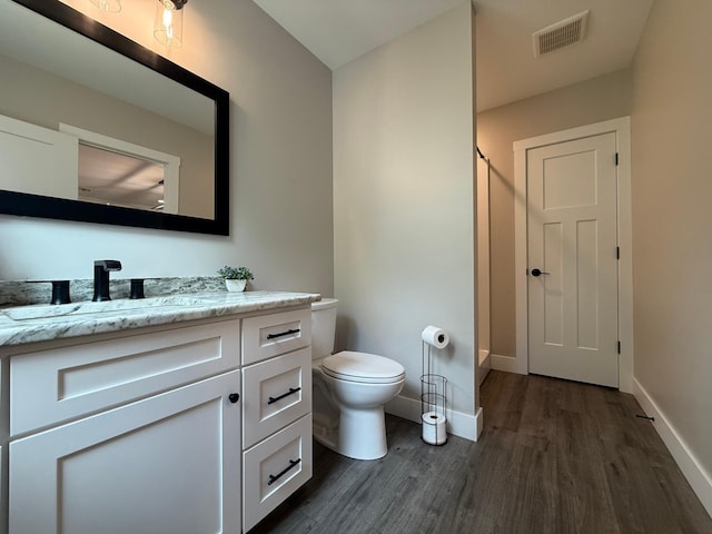 4615 County Road 5 NW, Byron, MN 55920 - full bath with wood finished floors, vanity, baseboards, and toilet