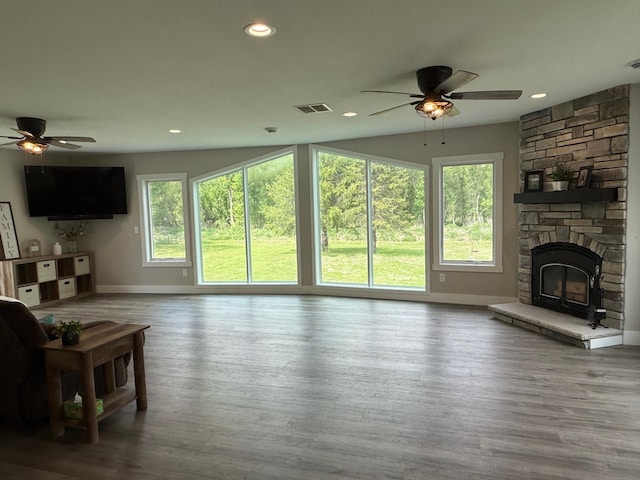 4615 County Road 5 NW, Byron, MN 55920 - living area with a ceiling fan, baseboards, a stone fireplace, recessed lighting, and wood finished floors