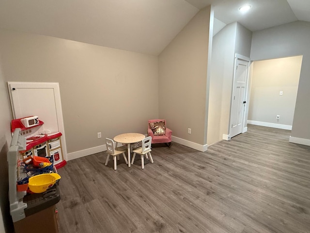 4615 County Road 5 NW, Byron, MN 55920 - playroom featuring wood finished floors, vaulted ceiling, and baseboards