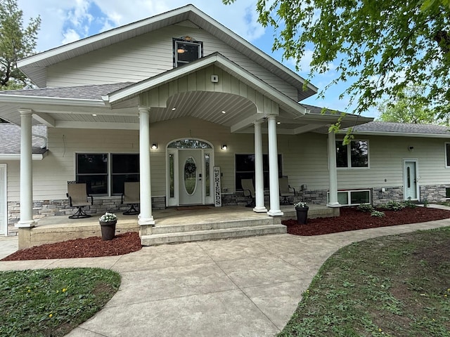 4615 County Road 5 NW, Byron, MN 55920 - view of front facade featuring covered porch, stone siding, and a shingled roof