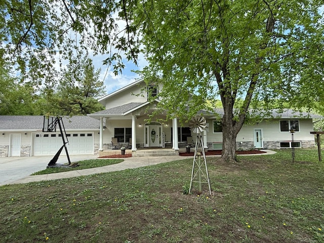 4615 County Road 5 NW, Byron, MN 55920 - view of front of house with covered porch, an attached garage, stone siding, and driveway