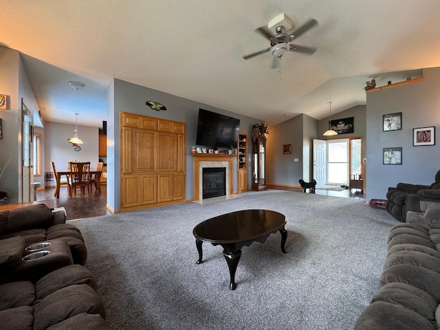 6158 Forest Boulevard Trl, Wyoming, MN 55092 - carpeted living area featuring ceiling fan, a fireplace with flush hearth, lofted ceiling, baseboards, and a textured ceiling