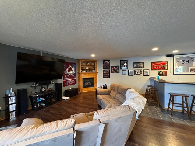 6158 Forest Boulevard Trl, Wyoming, MN 55092 - living room featuring a textured ceiling, bar, wood finished floors, recessed lighting, and a glass covered fireplace