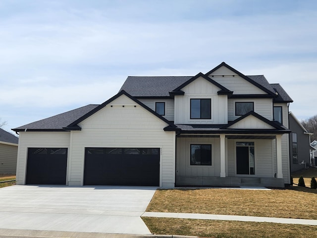 modern farmhouse featuring covered porch, driveway, a garage, and roof with shingles