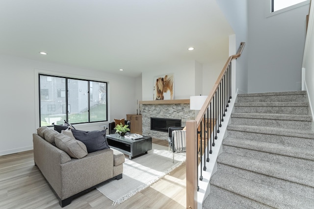 living room with light wood finished floors, stairway, plenty of natural light, and recessed lighting
