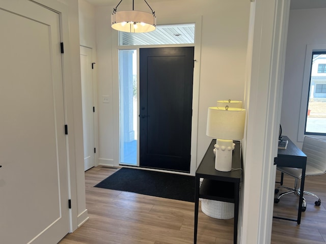 foyer featuring wood finished floors and baseboards