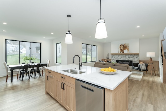 kitchen with dishwasher, a sink, light brown cabinetry, light wood-type flooring, and recessed lighting