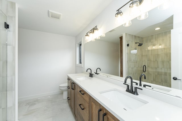 bathroom with a shower stall, baseboards, toilet, marble finish floors, and double vanity