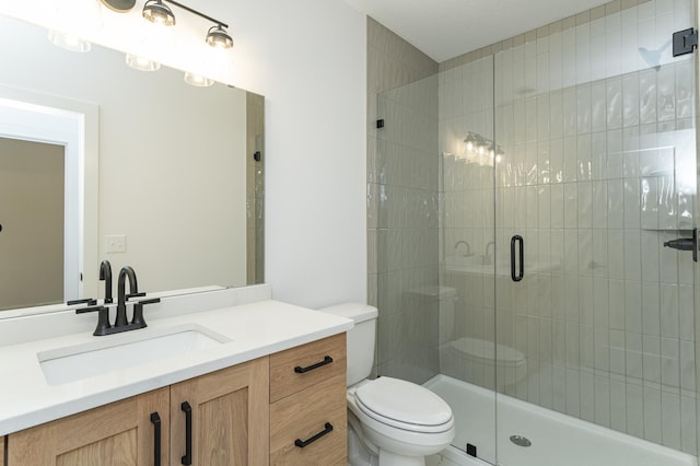 full bathroom featuring toilet, a stall shower, and vanity