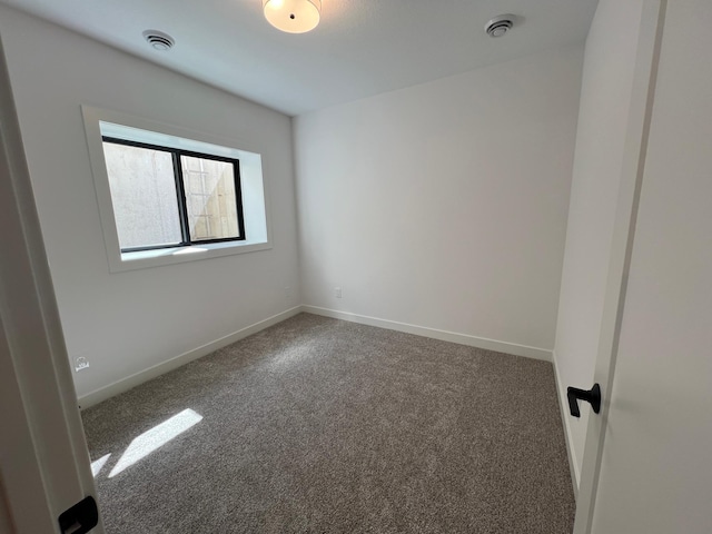 empty room with carpet flooring and baseboards