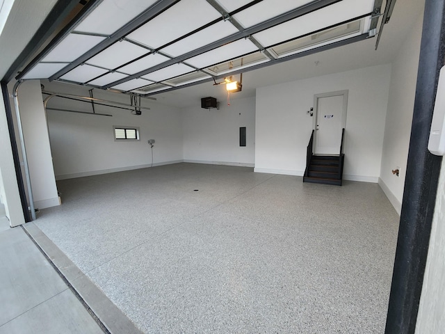 garage featuring baseboards and a garage door opener