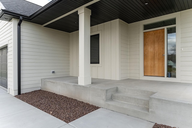 entrance to property featuring board and batten siding, roof with shingles, and a porch