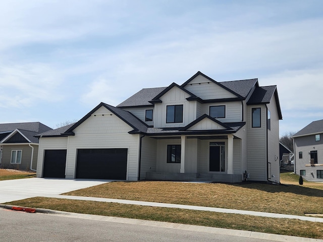 modern inspired farmhouse featuring board and batten siding, an attached garage, driveway, a porch, and a front lawn
