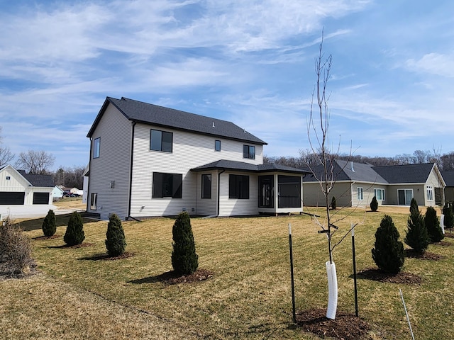back of property featuring a yard and a sunroom
