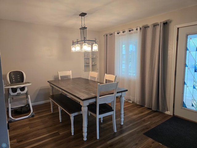 2105 7th St S, Moorhead, MN 56560 - dining space featuring dark wood finished floors, a chandelier, and baseboards
