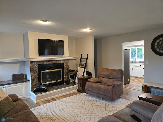 2105 7th St S, Moorhead, MN 56560 - living room featuring light wood-style floors and a high end fireplace
