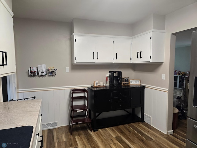 2105 7th St S, Moorhead, MN 56560 - kitchen featuring dark wood-type flooring, wainscoting, white cabinetry, and light countertops
