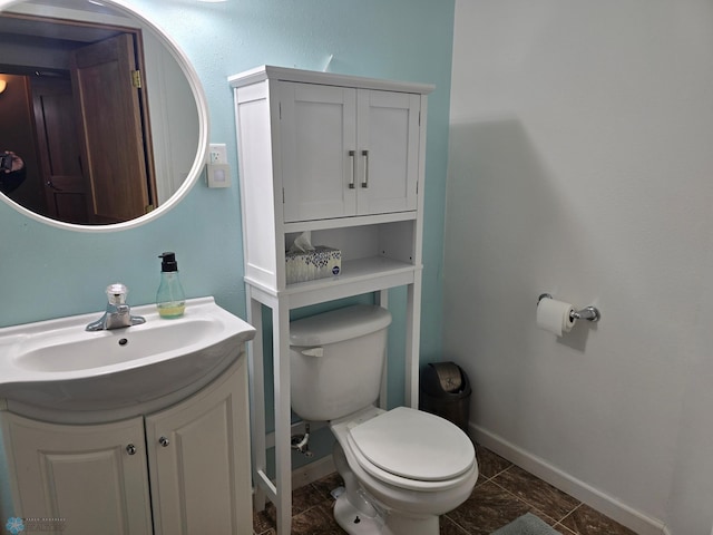 2105 7th St S, Moorhead, MN 56560 - bathroom with toilet, baseboards, and vanity
