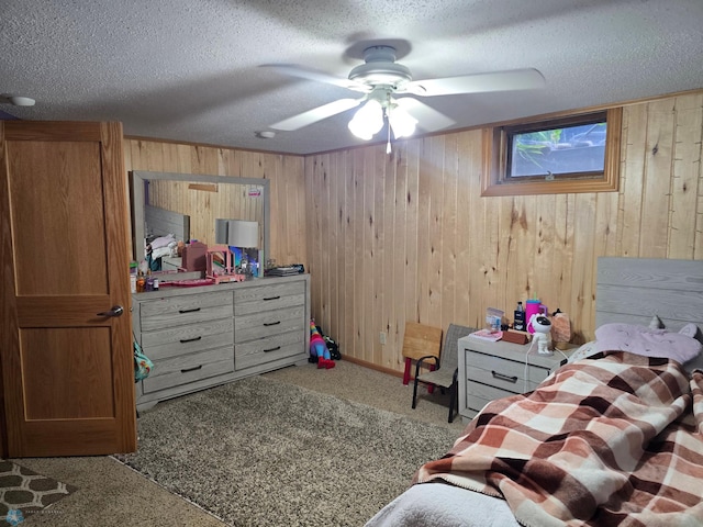 2105 7th St S, Moorhead, MN 56560 - bedroom with wooden walls, a textured ceiling, carpet flooring, and ceiling fan