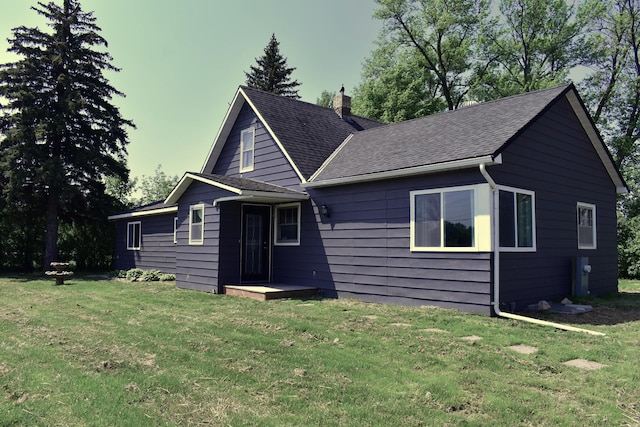 1706 Alcott Ave, Buse Twp, MN 56537 - view of front of house featuring a chimney, a front yard, and roof with shingles